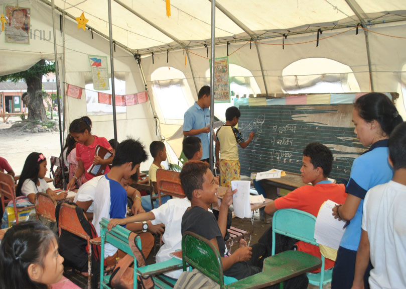 Classes are now on its final days as students from the San Fernando Elementary School listens to their student teachers from the Leyte Normal University inside their makeshift classroom. (LITO A. BAGUNAS)