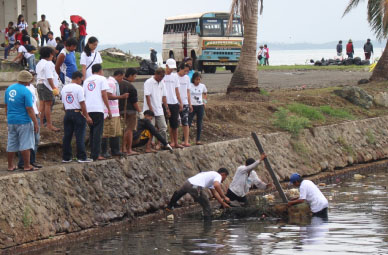 Volunteers cleans up the Cancabato Bay which was cluttered with debris during supertphoon Yolanda. (Photo courtesy of SAVE THE CHILDREN)