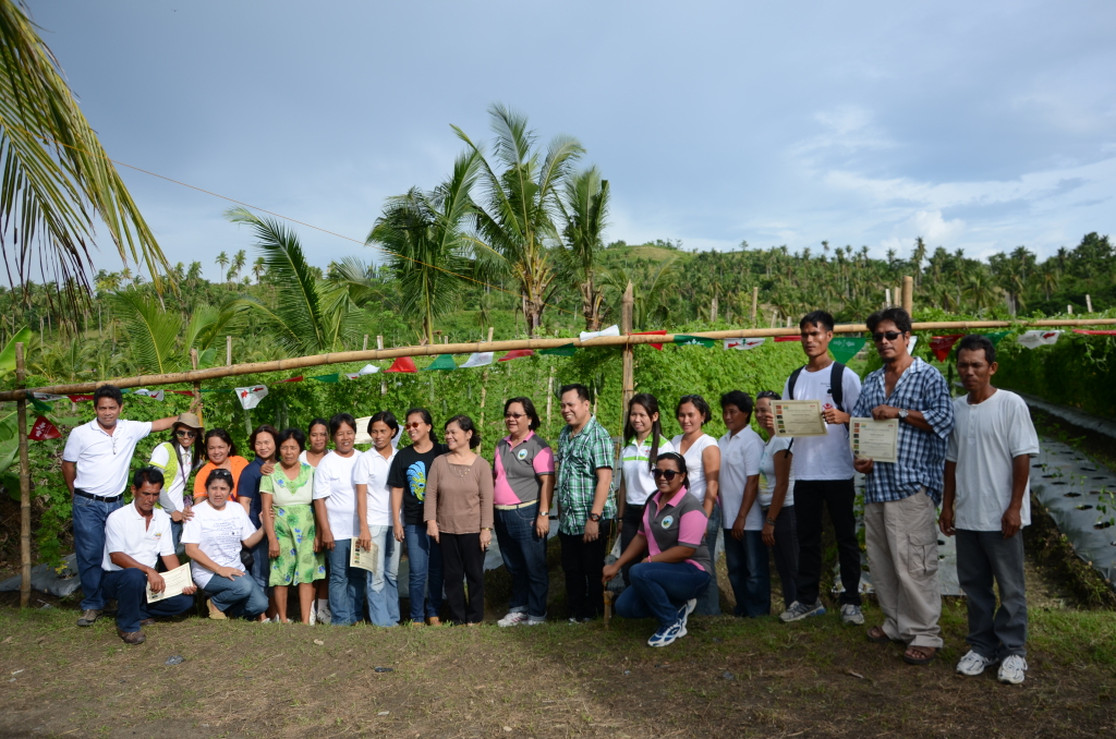 Assistant Regional  Director  Ismael  Aya-ay (standing 8th from right)  of  theDepartment of Agrarian Reform (DAR) and San Isidro, Leyte Mayor SusanAng (standing 9th from right) together with the East-West Seed Co. staff pose with the farmers who finished the season-long hybrid vegetable production conducted  by  the  East-West  Seed  Co.  under  the  DAR’s  Agrarian  Reform Communities Connectivity and Economic Support Services (ARCCESS) project in front of their demo farm.(JOSE ALSMITH L. SORIA)