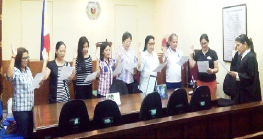 New officers and directors of Philippine Association of Court Employees-Region 8 take their oath before RTC Judge Evelyn Lesigues at the sala of RTC Branch 7.  (by PACE-Region 8)