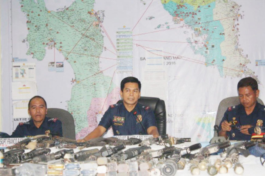 Acting Regional Director PNP-8 Police Chief Supt. Elmer C. Beltejar (center),  Leyte PNP Provincial Director Senior Supt. Franco P. Simborio (left) and Albuera Chief of Police Chief Inspector Jovy Espinedo presented to the media on Wednesday, August 3, assorted firearms and several live and spent ammunitions recovered at the residence of Albuera Mayor Rolando Espinosa, Sr. in Brgy. Binolho, Albuera town.  Espinosa is linked to a big illegal-drugs trade in the region. MEL CASPE