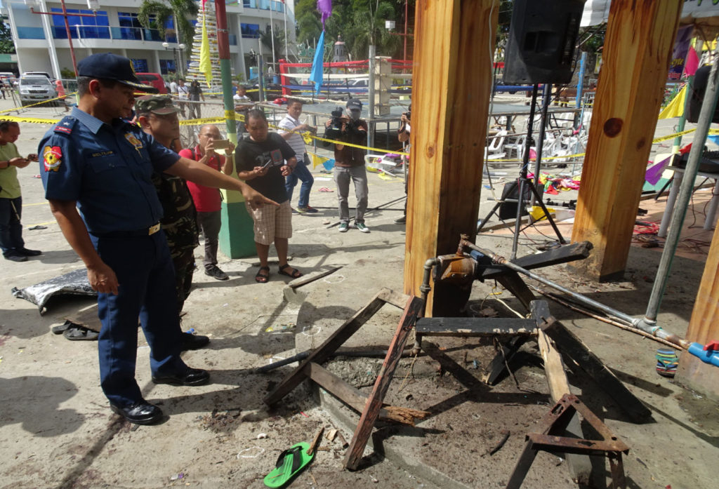 JUSTICE. Police authorities in the region are working double time to identify and arrest the perpetrators behind the explosions incident in Hilongos, Leyte that resulted to the injury of 32 people on December 28. Seen in photo is PNP Regional Director Chief Supt. Elmer Beltajar conducting an inspection at the blasts site at the Rizal Park in Hilongos.  
